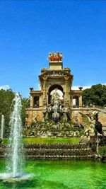 Fountain against clear blue sky