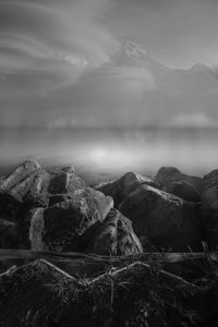 Scenic view of sea and mountains against sky