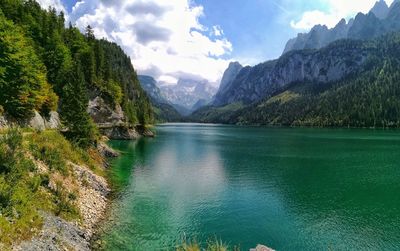 Scenic view of lake and mountains against sky