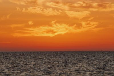 Scenic view of sea against romantic sky at sunset