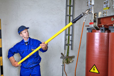 Man working against wall