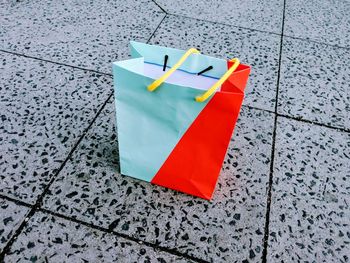 High angle view of paper bag on tiled floor