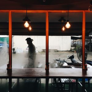 Man standing in illuminated room