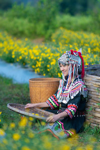 Woman with flowers in basket on field