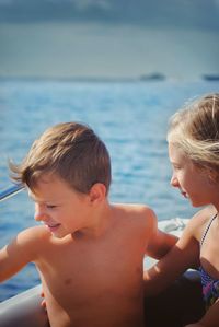 High angle view of shirtless boy in sea