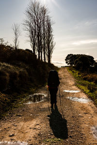 A young girl is walking on the camino de santiago on a path near uterga.