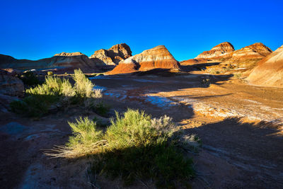 Scenic view of mountains against clear blue sky