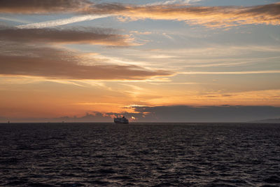 Ships sailing in the mediterranean sea with a sunset