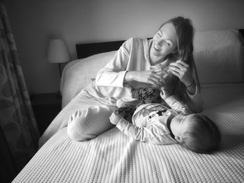 Mother and daughter on bed at home