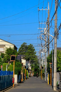 Empty road with buildings in background