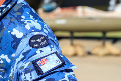 Close-up of flags against blue wall