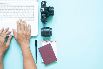 Directly above shot of human hand on table against white background