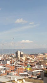 High angle view of buildings in city against sky