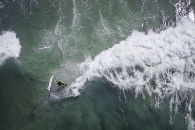 High angle view of man surfing in sea