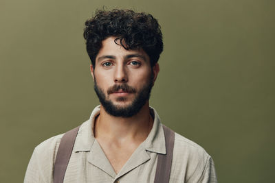 Portrait of young man against gray background