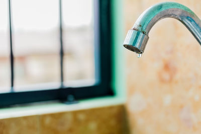 Close-up of faucet in bathroom