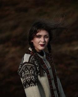 Portrait of smiling woman standing outdoors