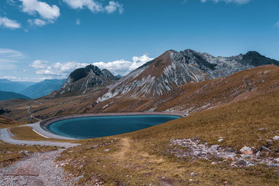 Scenic view of snowcapped mountains against blue sky
