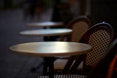 Empty chairs and tables at outdoor cafe