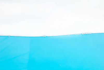 Swimming pool by sea against clear sky