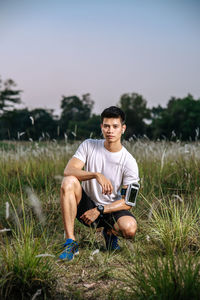 Young man sitting on field