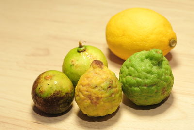 Close-up of kaffir limes on wooden table