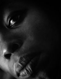 Close-up portrait of woman in darkroom