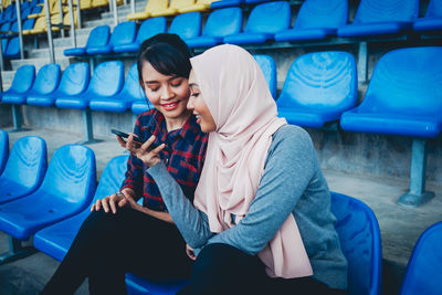 Full length of woman using mobile phone