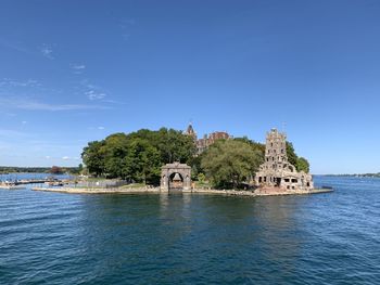 Building by sea against blue sky