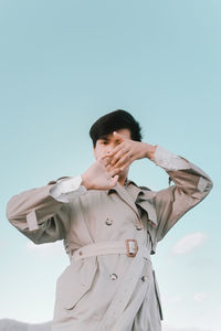 Low angle view of man standing against sky