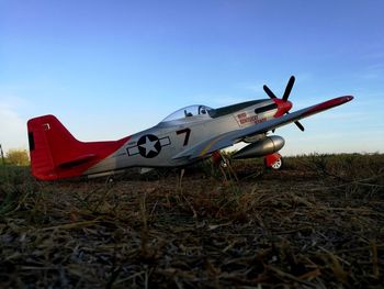 Airplane on field against clear sky