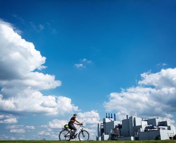 Man with bicycle against building in city