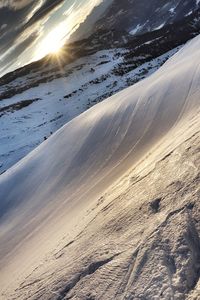 Scenic view of sand dunes against sky during sunset