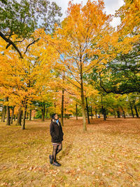 Rear view of woman walking on field