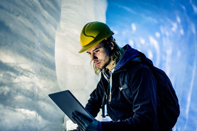 Young man using smart phone in winter