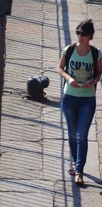 Young woman standing on wall