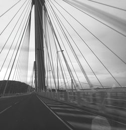 Bridge against sky seen through car windshield
