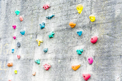 Full frame shot of colorful handgrips on old wall
