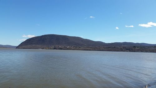 Scenic view of mountains against blue sky