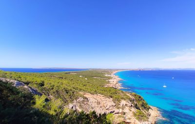 Scenic view of sea against clear blue sky