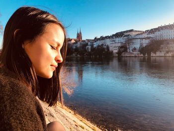 Close-up of beautiful young woman by river 