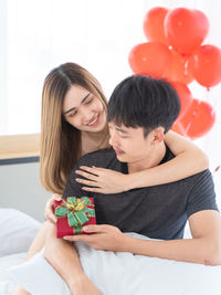 Young couple holding hands in box