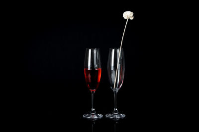 Glass of wine against black background