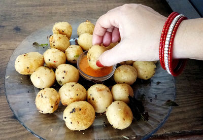 Suji appe or rice appe or appam, an indian snack with onion, peanuts and tamarind dip in india