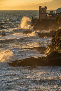 Waves on the promenade on the cliffs of nervi, in the outskirts of genoa, italy