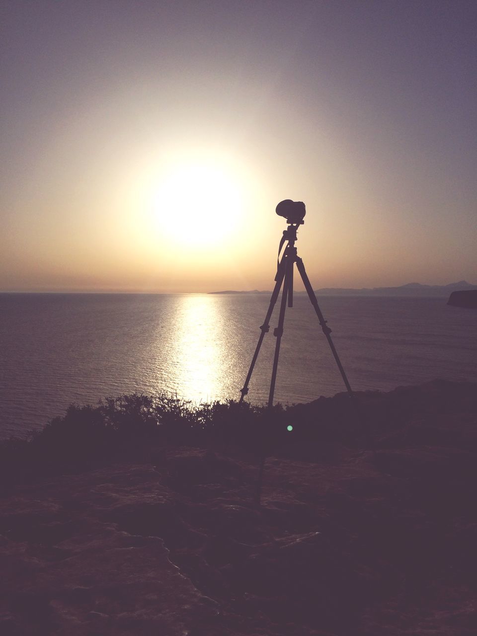 sky, sea, horizon, tripod, horizon over water, sunset, scenics - nature, photography themes, water, beach, photographic equipment, no people, technology, camera - photographic equipment, tranquility, tranquil scene, land, silhouette, nature, sun, outdoors, digital camera