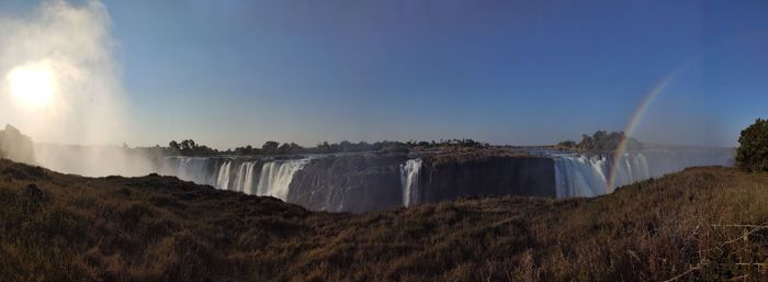 Panoramic view of waterfall against sky