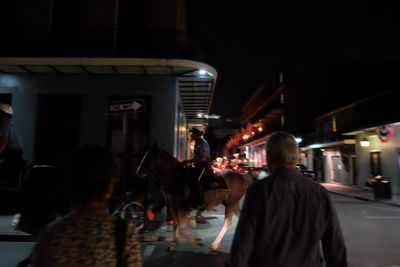 People in illuminated city at night