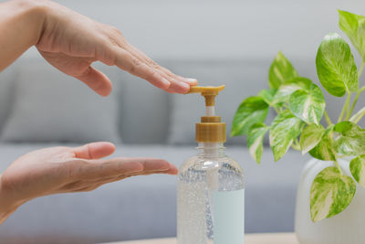 Close-up of hand holding glass bottle
