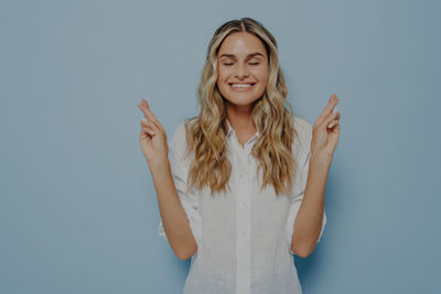 Portrait of young woman against white background